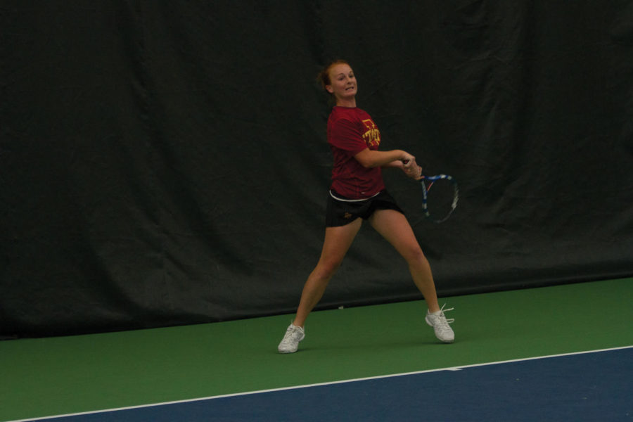 ISU player Meghan Cassens returns the ball during singles play against Kansas State on Friday, April 13. Cassens won her first set 6-4 and lost her second 2-6. The event took place indoors at the Ames Racquet and Fitness due to weather conditions. 
