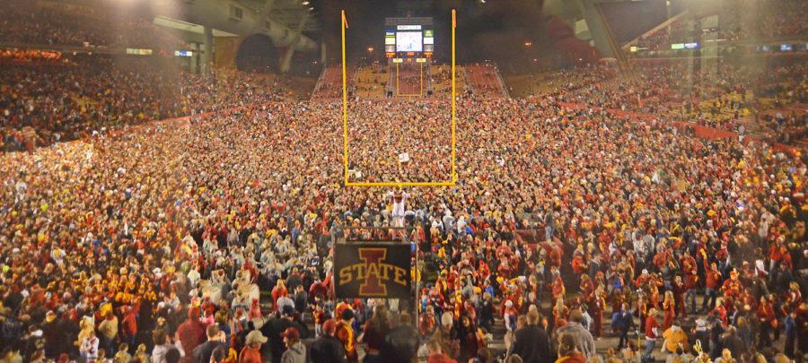 ISU fans storm the field after Iowa State won the game against Oklahoma State in double overtime. Iowa State won over Oklahoma State 37-31. Photo courtesy of Adam Kemp/OCollegian
