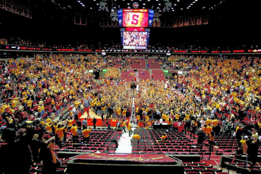 After beating the Kansas Jayhawks 72-64, the ISU mens
basketball team celebrate as fans storm the court in
celebration.
