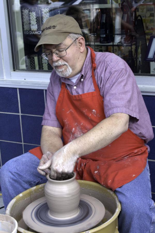 Greg Lamont throws a pot at the 18th annual ArtWalk in downtown Ames on June 1, 2012. The ArtWalk is a good example of an the event that the Ames Cultural District puts on. 
