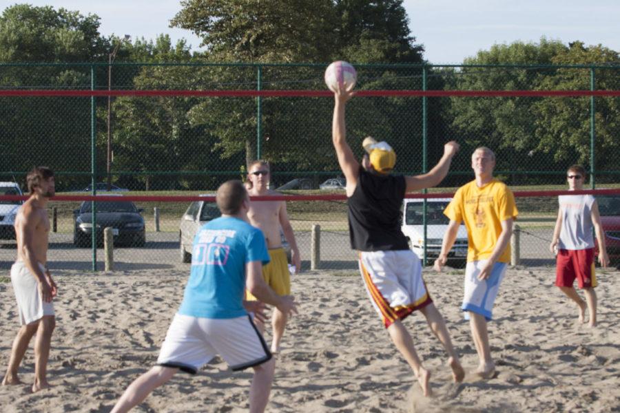 Team members of We Will We Will Block You and Diggers with Attitude compete in the summer intramural men's sand volleyball championship match Tuesday, July 17, at the southeast intramural fields. We Will We Will Block You won the championship in two sets.
