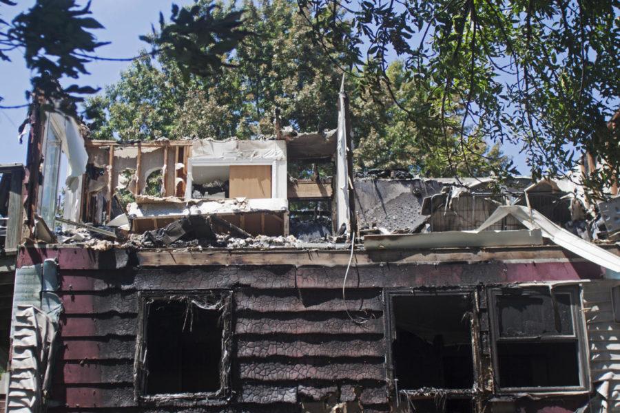 Tenants of 301 S. Fifth St., one of the South Meadow apartment buildings, move their belongs out of the water and fire damaged apartments Monday, July 16, the day following a fire that caused significant damage to the building. 
