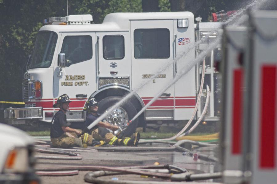 Firefighters work to contain a fire on Sunday, July 15, at 301 S. Fifth St., one of the South Meadow Apartment buildings. According to a city of Ames news release, all three Ames fire stations responded to the fire and firefighters will continue to monitor the fire through the night.
