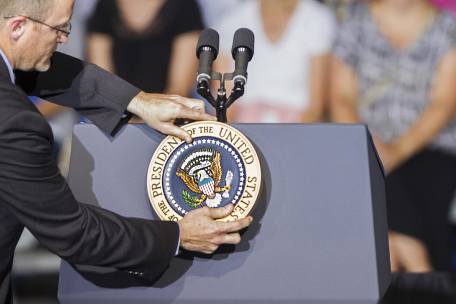 A man places the presidentical seal on the podium before Barack Obamas speech in the Herman Park pavilion on Monday, Aug. 13 in Boone, Iowa. Boone was the presidents second official stop on his bus tour through Iowa this week.
