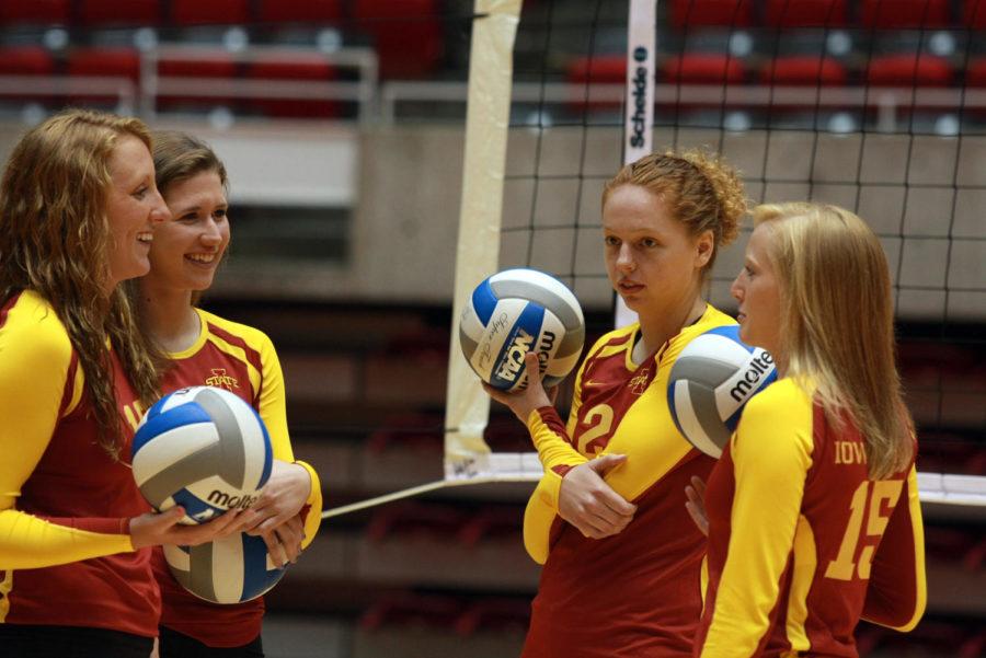 Teammates chat during the womens volleyball media day Thursday, Aug. 9, at Hilton Coliseum. The team will have a scrimmage on Saturday, Aug. 18, at Hilton.
