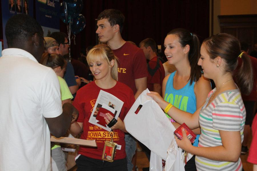 Hannah Statler, freshman in apparel, merchandise and design; Alex Bonn, freshman in event management; and Becca Vonnahme, freshman in marketing, learn about recreation services Wednesday, Aug. 22, during WelcomeFest in the Great Hall of the Memorial Union. 
