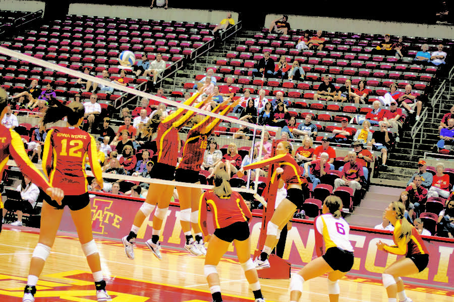 Players jump up for a block during womens volleyball scrimmage Saturday, Aug. 18, at Hilton Coliseum.
