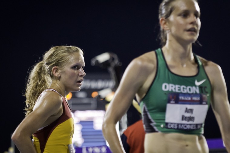 Lisa Koll, left, looks on after sharing a hug with Amy Begley at the conclusion of the Womens 10,000-meter run on Thursday at Drake Stadium. Begley finished first with Koll coming in second at 32.11.72. Photo: Logan Gaedke/Iowa State Daily