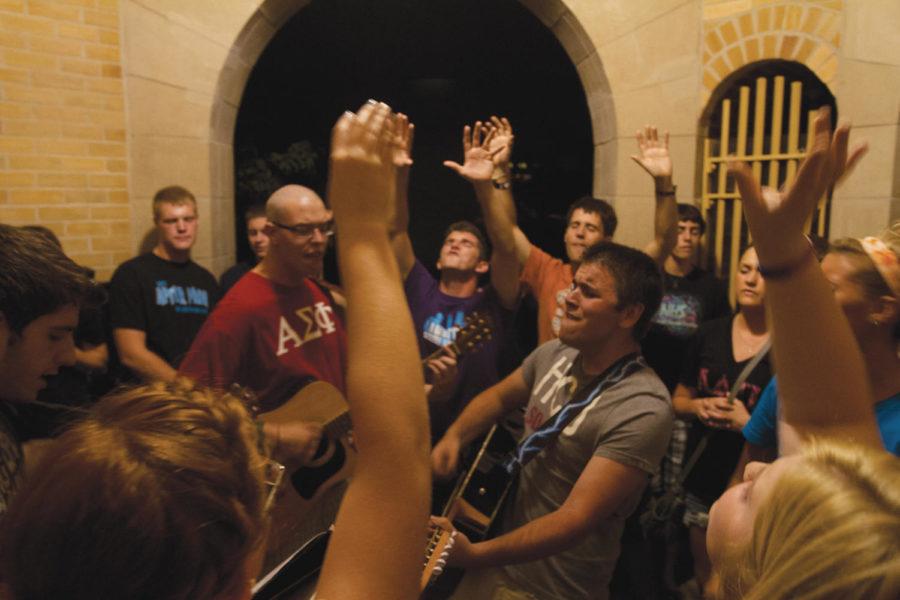 A group of students gather together under the Campanile on Central Campus to sing worship songs at 9 p.m. every Wednesday. 
