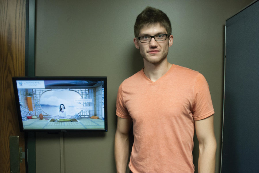 Jeritt Tucker, graduate in psychology, stands next to a monitor in the biofeedback center located in the Student Services Building.
