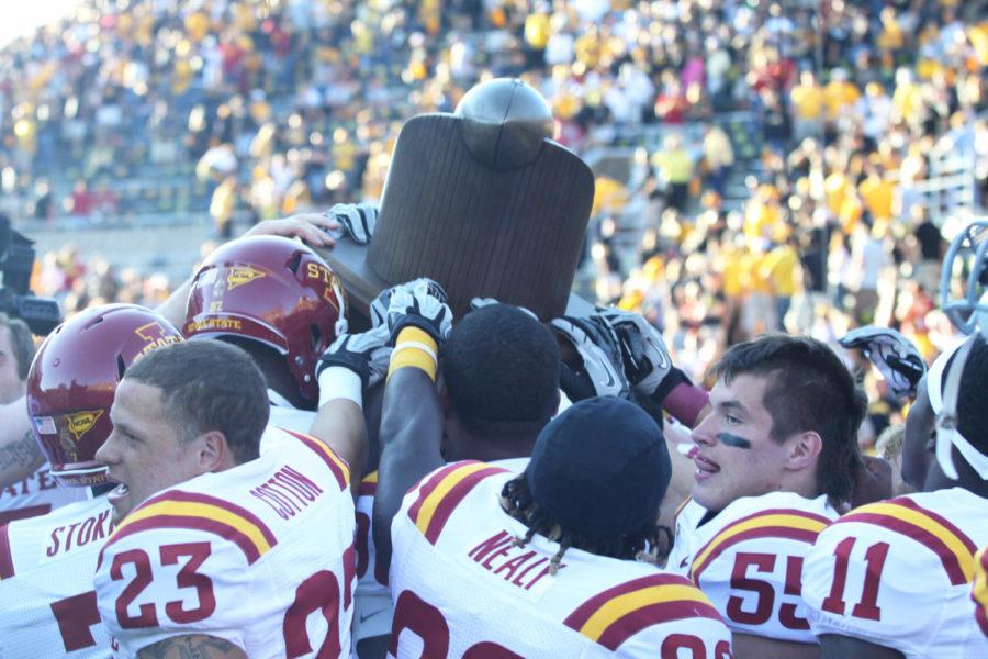 Cyclones players lift high their trophy after winning the game Saturday, Sept. 8, at Kinnick Stadium. Cyclones beat hawkeyes with 9-6. 
