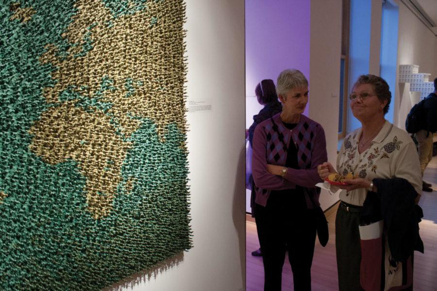 Art aficionados enjoy refreshments while observing the work of artist Andy Magee during the Post-Pop Redux reception Thursday, Sept. 27, at the Christian Petersen Art Museum at Morrill Hall.
