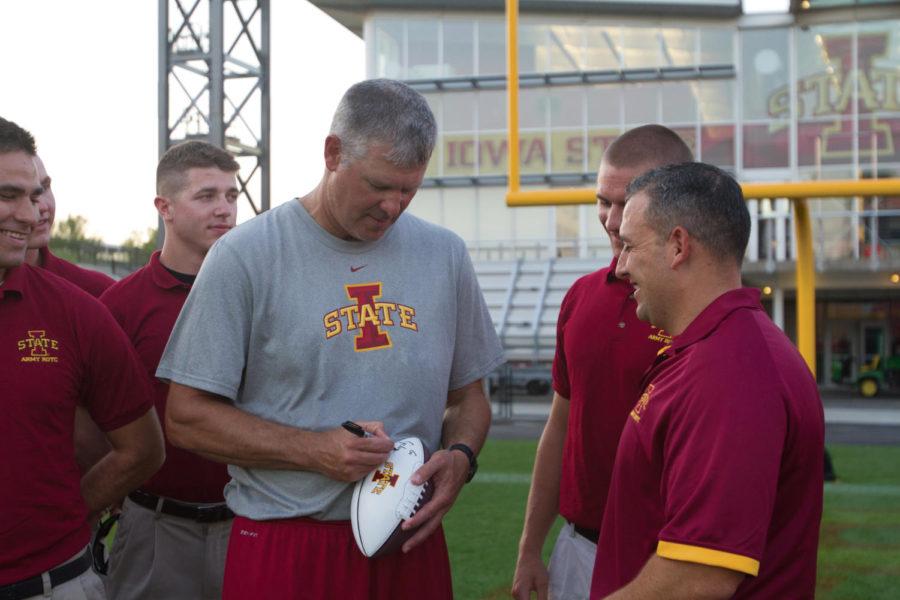 Coach Paul Rhoads signs the Cy-Hawk game ball, which will be sent off to Iowa City on Friday morning. The ball will be presented by both ISU and U of I ROTC programs at the game on Saturday in Iowa City.
