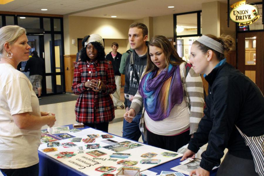 Julie Wilber of Wilbers Northside Market speaks with students about what the store offers to the dining centers Thursday, Oct. 18, in the Union Drive Community Center. Local farmers were on campus Thursday to present what is grown locally for the campus dining centers.
