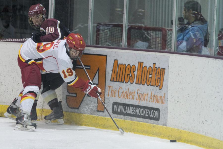 Jonathon Feavel, forward, fights for the puck against a player
from Robert Morris University on Saturday, Jan. 28, at the ISU/Ames
Ice Arena. The Cyclones lost to the Eagles 6-4 on Saturday
night.
