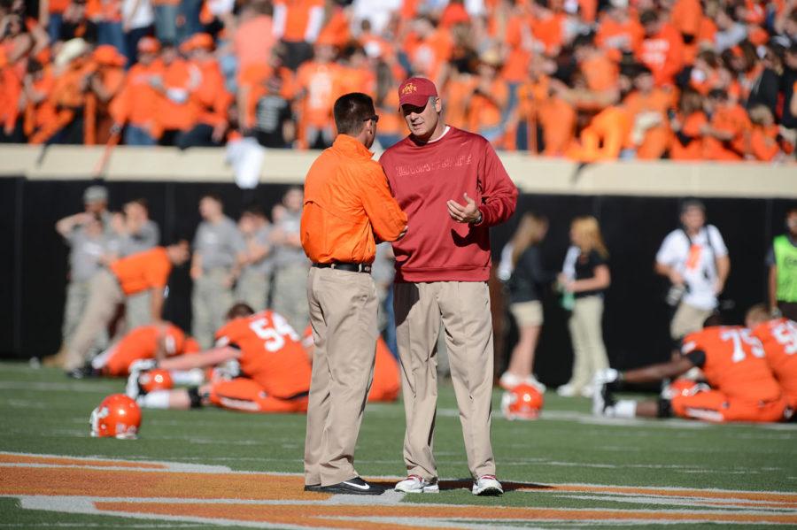 OSU head coach Mike Gundy talks with ISU head coach Paul Rhoads before the game on Saturday, Oct. 20, at Boone Pickens Stadium.
