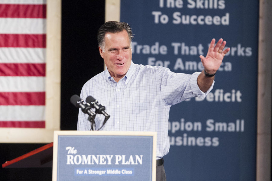Presidential hopeful, Mitt Romney waves to audience members as he takes the stage of the Central Campus auditorium Wednesday, Aug. 8, in Des Moines. 
