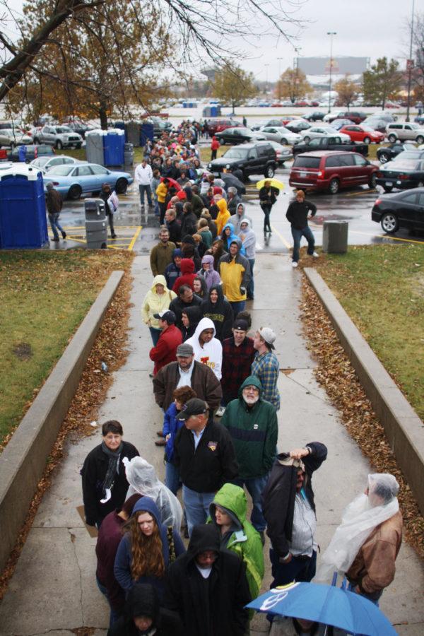 People wait in the rain Thursday, Oct. 18, 2012, outside of Hilton Coliseum to see Bruce Springsteen perform.
