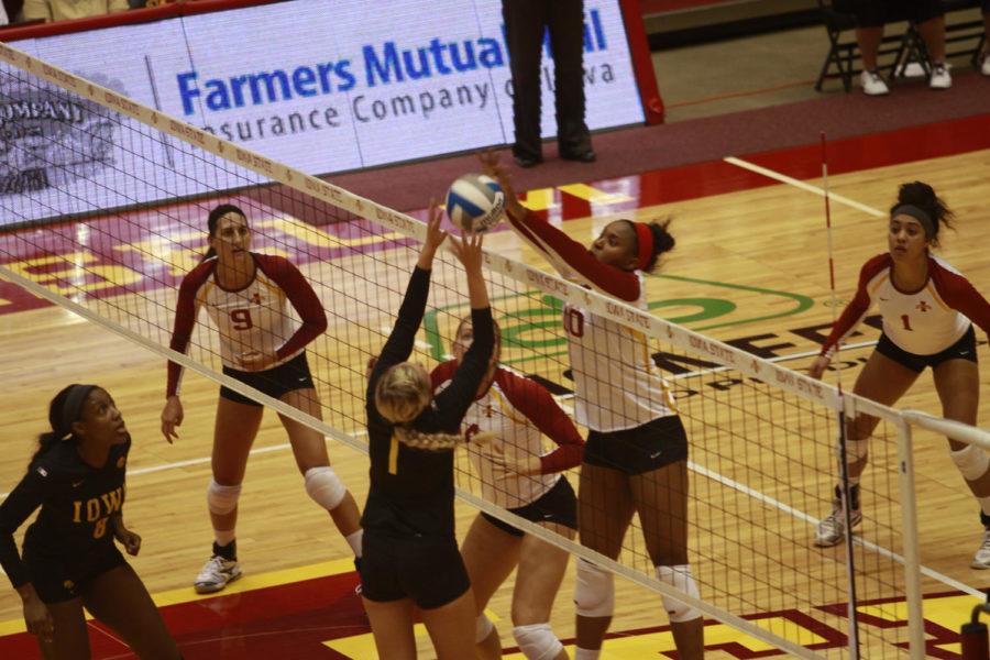 Victoria Hurtt jumps up to block the ball Friday, Sept. 7, at Hilton Coliseum. Iowa State defeated Iowa 3-2. 
