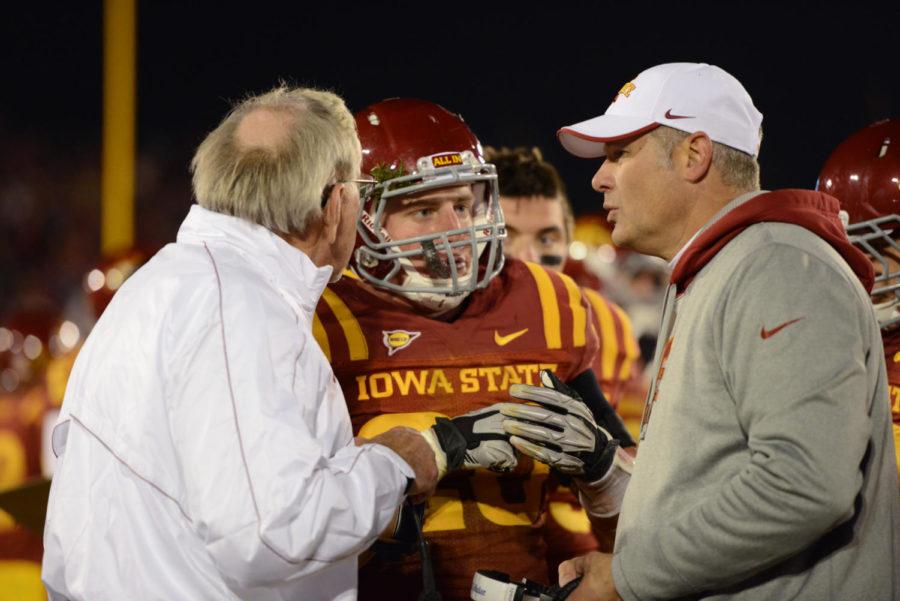 Jake Knott talks to coaches Paul Rhoads and Wally Burnham during the game against Baylor on Saturday, Oct. 27, at Jack Trice Stadium. Knott recorded 11 tackles during the Homecoming game.

