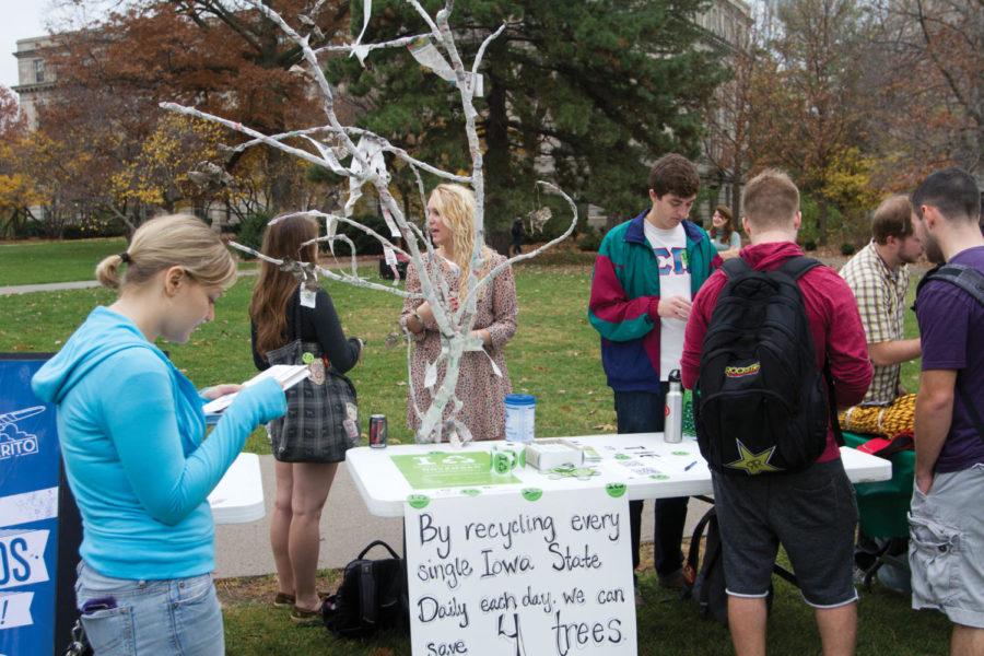 Members of The Green Umbrella talk with students near their papercraft tree in front of Parks Library.  Iowa State hosted an awareness event for National Campus Sustainability Day on Wednesday, Oct. 24.

