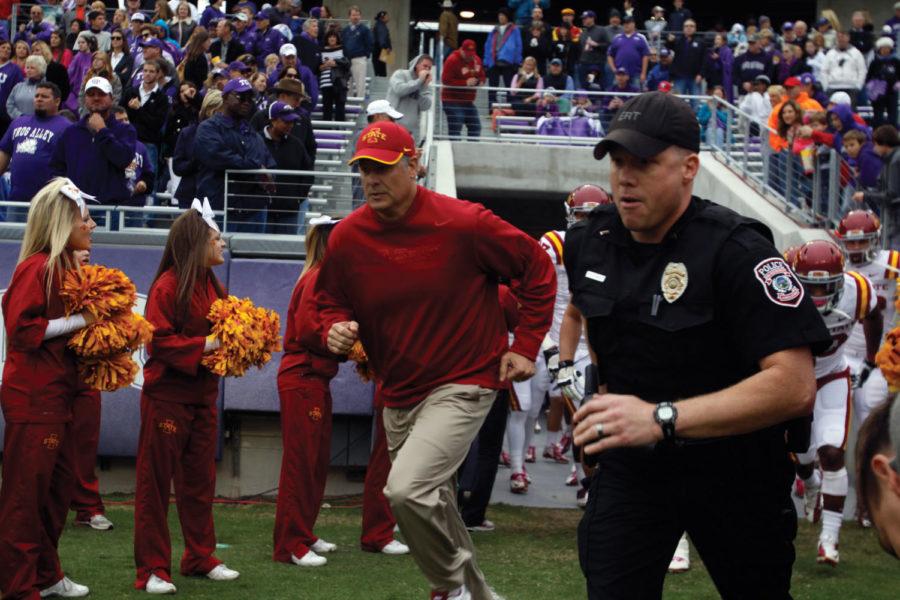ISU football coach Paul Rhoads leads the team into the Amon G. Carter Stadium before the game against TCU on Oct. 6. The Cyclones went on to win their first conference game of the season in a 37-23 victory.
