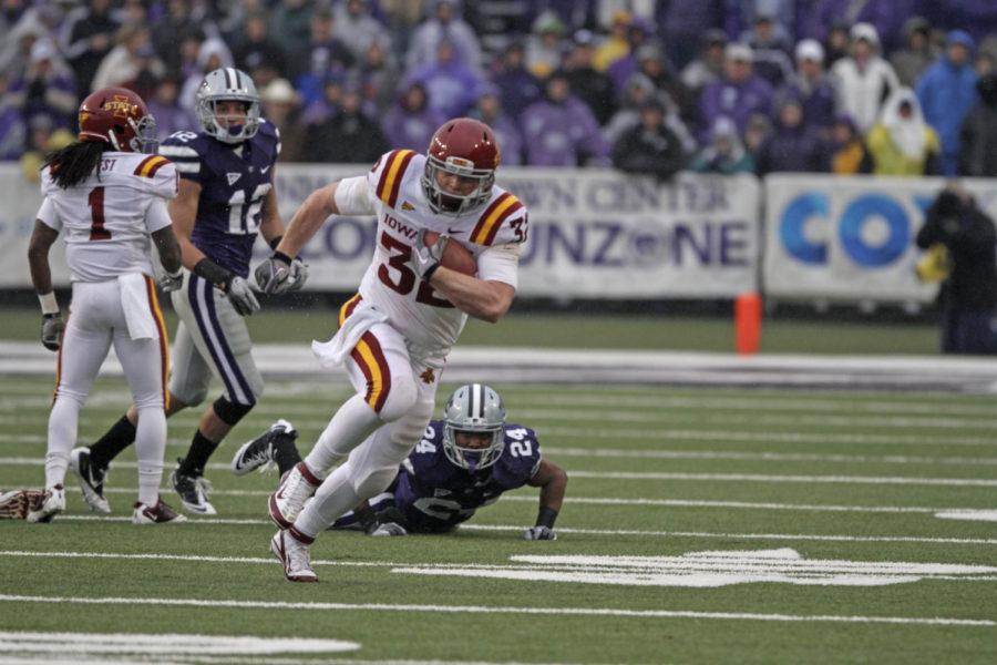 ISU running back Jeff Woody breaks a tackle during the first quarter of Iowa States 30-23 loss to No. 11 Kansas State on Saturday in Manhattan, Kan. Woody tallied career highs in carries (24), rushing yards (86) and touchdowns (two) for the Cyclones in the loss.