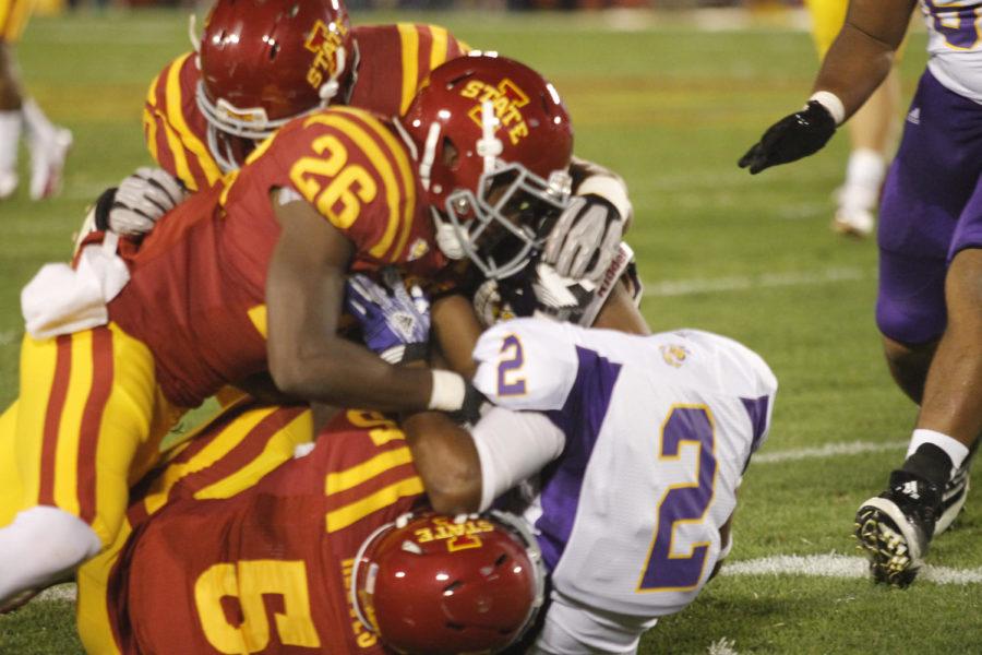 Deon Broomfield (No. 26) and Jeremy Reeves (No. 5) tackle Charles Chestnut of the WIU Leathernecks on Saturday, Sept. 15, at Jack Trice Stadium. The Cyclones won 37-3.
