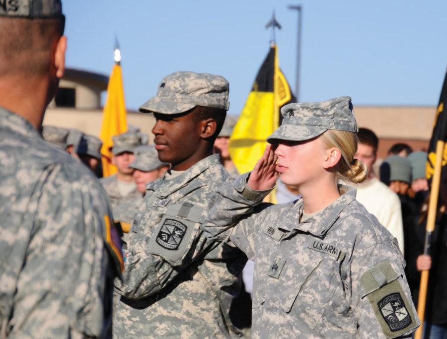 Amanda Veen, right, receives the individual award for the 10K ruck march. Stephen Brown, left, is the guidon bearer.
