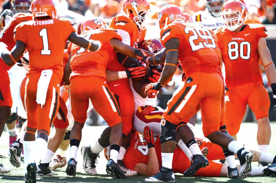 Shrontrelle Johnson gets tackled by a group of OSU players at the on Saturday, Oct 20, at Boone Pickens Stadium. Johnson ran the ball eight times for 24 yards in the 31-10 loss to Oklahoma State.
