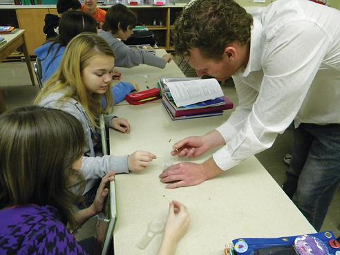 Mark Newell, graduate in agronomy teaches students at Brody Middle School in Des Moines about pollination.