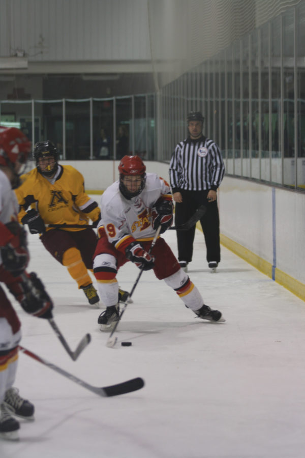 Jon Feavel, forward, skates with the puck Saturday, Jan. 22 at the ISU/Ames Ice Arena. The Cyclones beat the Golden Eagles 14-2.