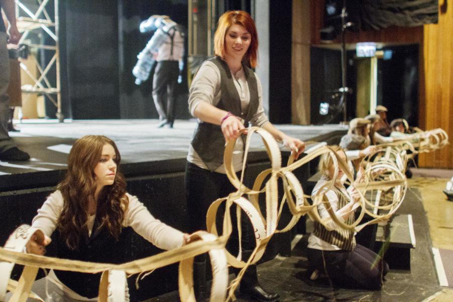 Meghan Berkland, left, sophomore in performing arts, and Shayla Cudd, sophomore in performing arts, practice moving a part of the Jabberwockys tail before the first Alice in Wonderland dress rehearsal Nov. 27, 2012, in Fisher Theater. 