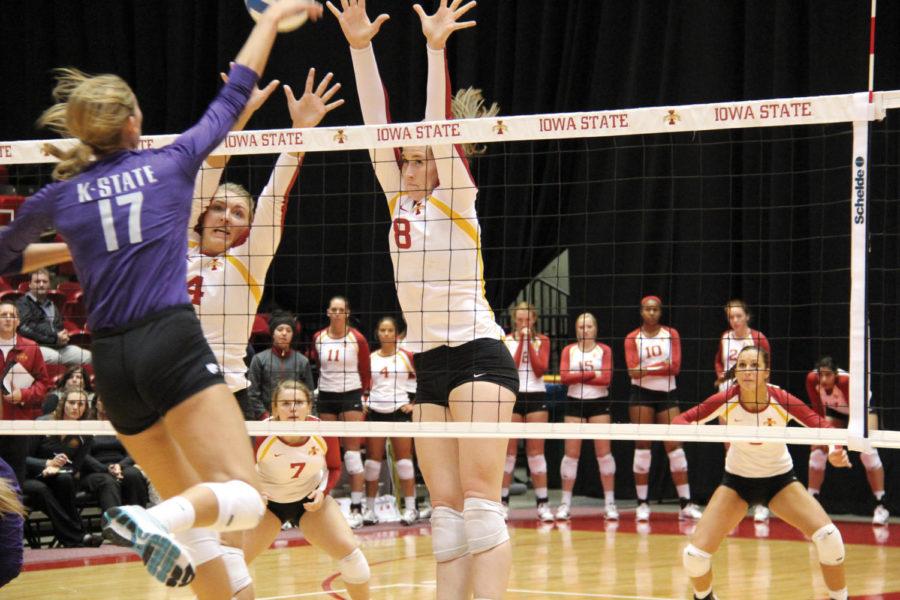 Freshman+Andie+Malloy+and+senior+Jamie+Straube+jump+up+to+block+the+ball+from+Texas+players+Wednesday+at+Hilton+Coliseum.%0A
