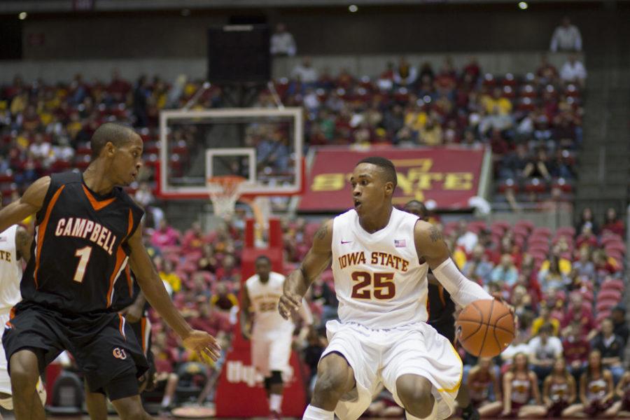 No. 25 Tyrus McGee attempts to avoid a Campbell opponent. The ISU mens basketball team defeated Campbell 88-68 on Sunday, Nov. 18, at Hilton Coliseum.
