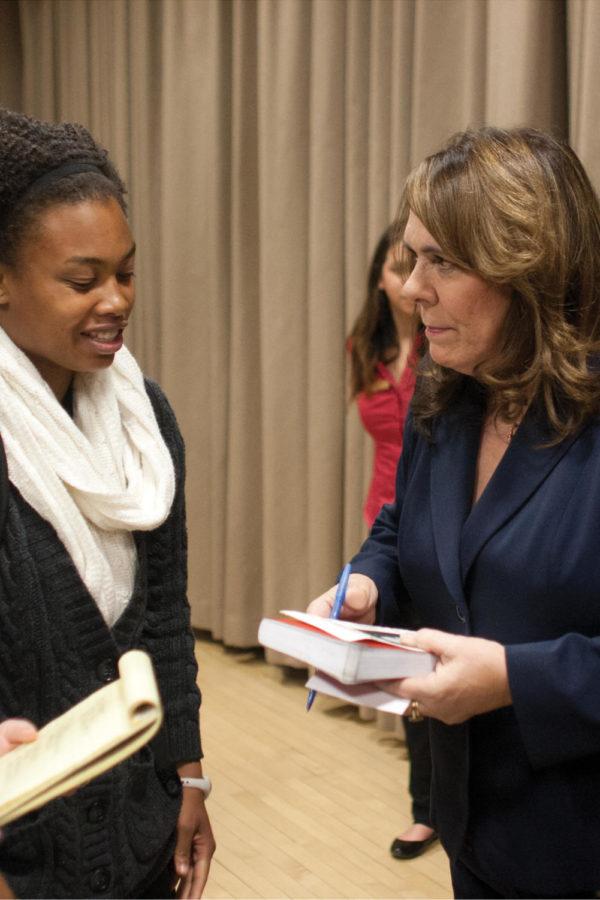 Candy Crowley, of CNNs State of the Union, signs a note for Ebony Jackson, sophomore in business, after Crowleys postelection analysis lecture Tuesday, Nov. 13, in the Sun Room of the Memorial Union. 
 
