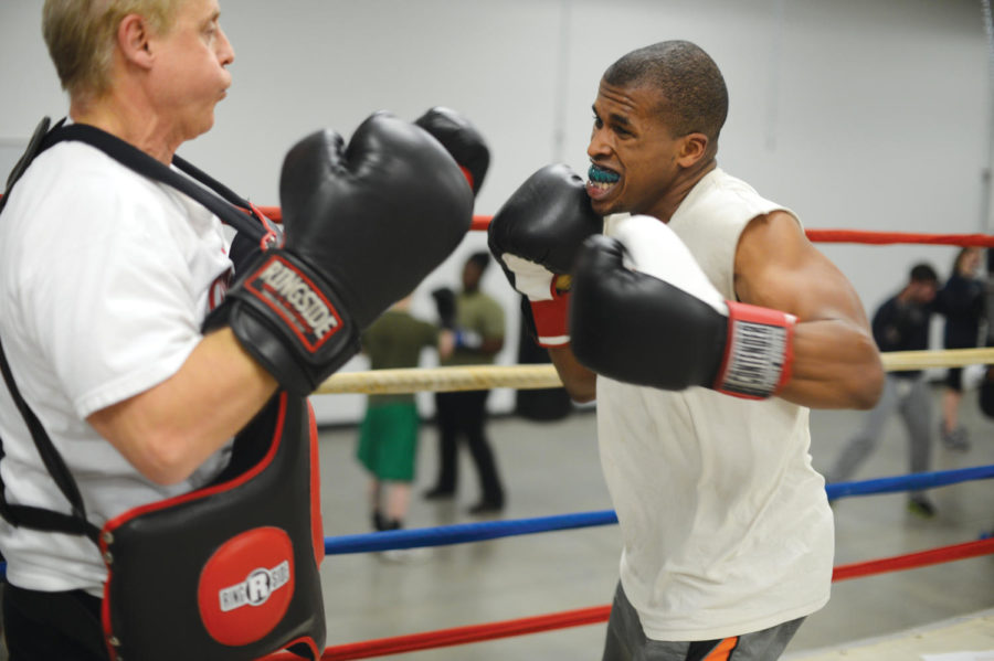 Boxer Dave Glenn practices Monday, Nov. 12, at State Gym with his coach for his march coming up in New York. Glenn has been chosen by New York City Athletic Club as one of the top two boxers in his weight class.
