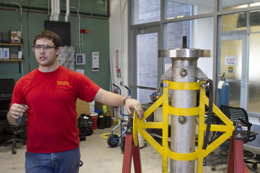 Nicholas Creager, graduate research assistant in mechanical engineering, shows the condensing equipment used in a research experiment. 
