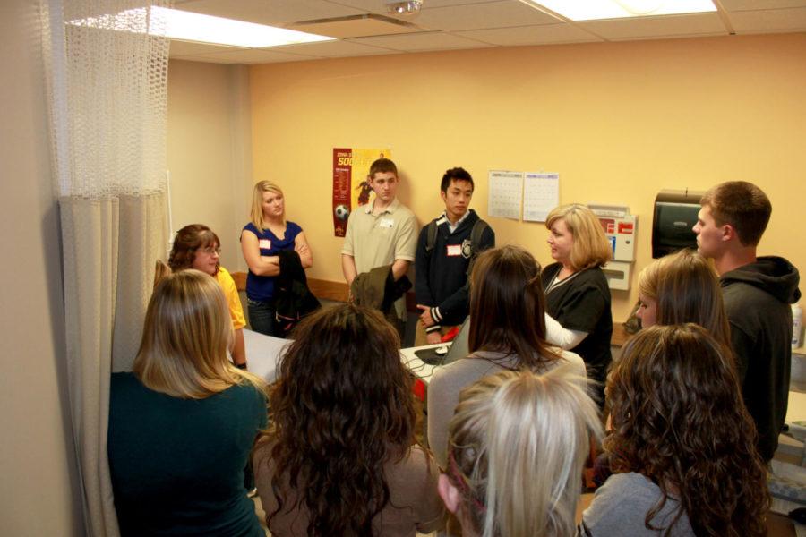 Kelly Frizzell, RN, demonstrates nursing to a group of students during a mock clinic trial Wednesday, Nov. 7, at Thielen Student Health Center
