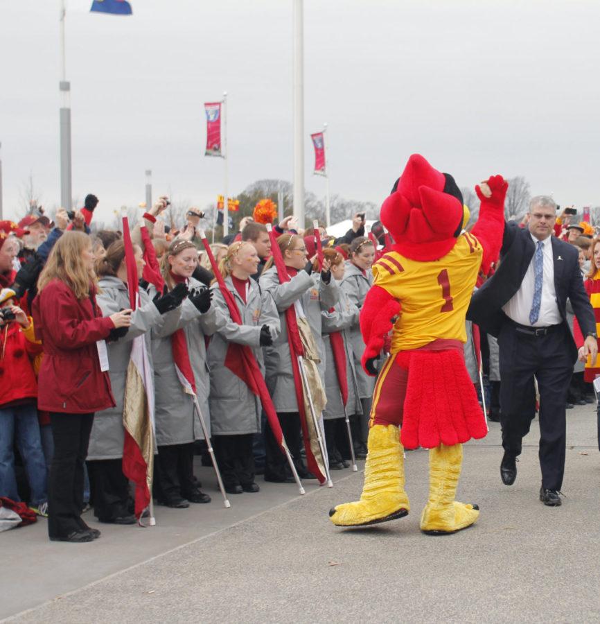 Head coach Paul Rhoads high fives Cy, as he leads the Cyclones in the Spirit Walk before playing the Tulsa Golden Hurricane in the Liberty Bowl, Monday, Dec. 31, in Memphis, Tenn. The Golden Hurricane won the bowl game 31-17.
