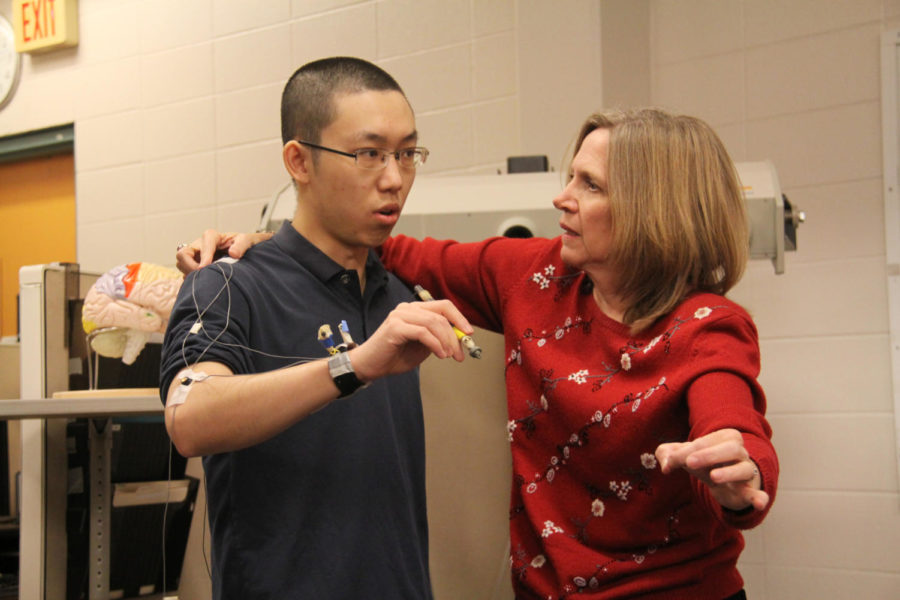 Ann Smiley-Oyen, associate professor of kinesiology, demonstrates her research with Chen Deng, graduate student in kinesiology, by using Optotrak, a system which traces and monitors someones movement and coordination, in her research lab located in Forker.
