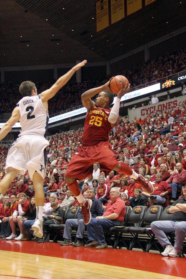 Tyrus McGee, No. 25, looks to swing the ball against the BYU defense. The Cyclones played the Cougars Saturday, Dec. 1, winning with a score of 83-62.  
