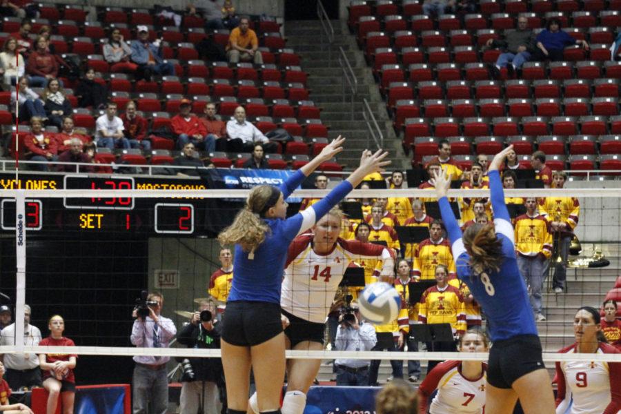 ISUs Jamie Straube sends the ball past two IPFW players Thursday, Nov. 29, at Hilton Coliseum. The Cyclones won the match 3-2.

