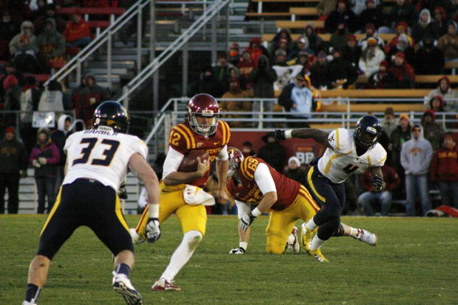 ISU quarterback Sam Richardson looks to run past West Virginia Mountaineer linebacker Jared Barber on Friday, Nov. 23, at Jack Trice Stadium. Richardson led the Cyclones in rushing for the game, running for 119 yards.
