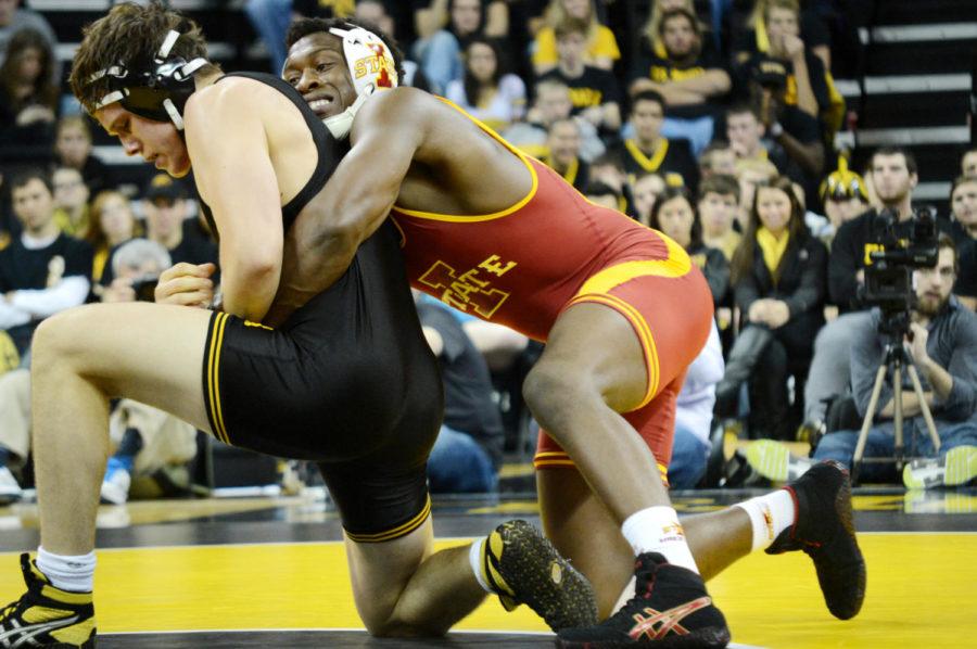 Iowa States Kyven Gadson moves in for a takedown against Iowas Nathan Borak during their 197-pound match at the meet on Saturday, Dec. 1, at Carver-Hawkeye Arena in Iowa City.
