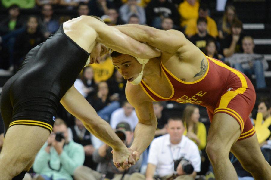 Mike Moreno grapples with Iowas Nick Moore in their 165-pound match in Iowa States 32-3 loss on Saturday, Dec. 1, at Carver-Hawkeye Arena.
