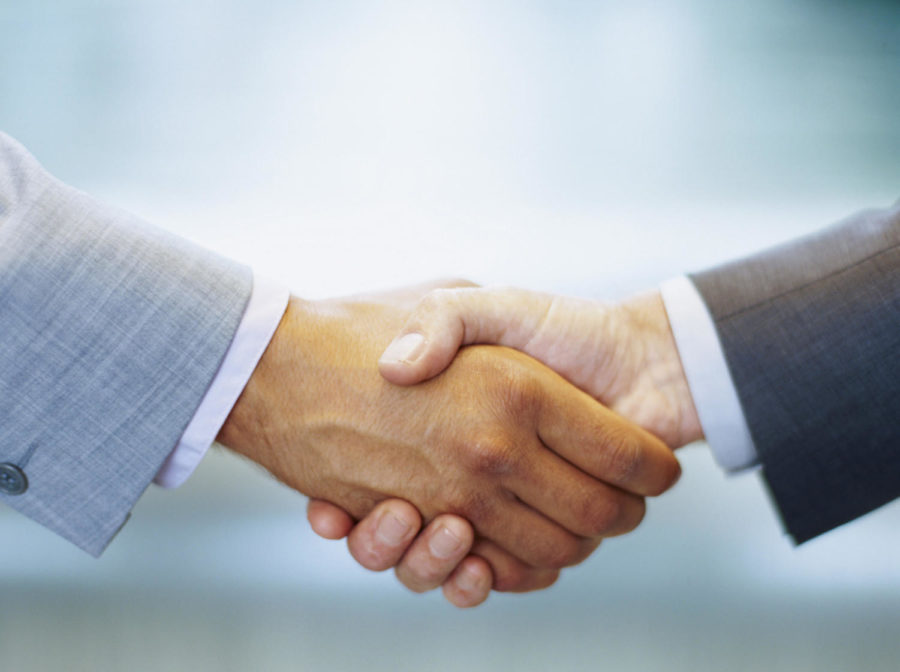 two business executives shaking hands
