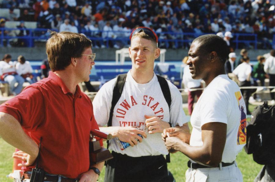 Steve Lynn, left, Jason Woods and Danny Harris talk during a track meet. Lynn helped coach Harris to three national championships and a silver medal at the 1984 Summer Olympics.
