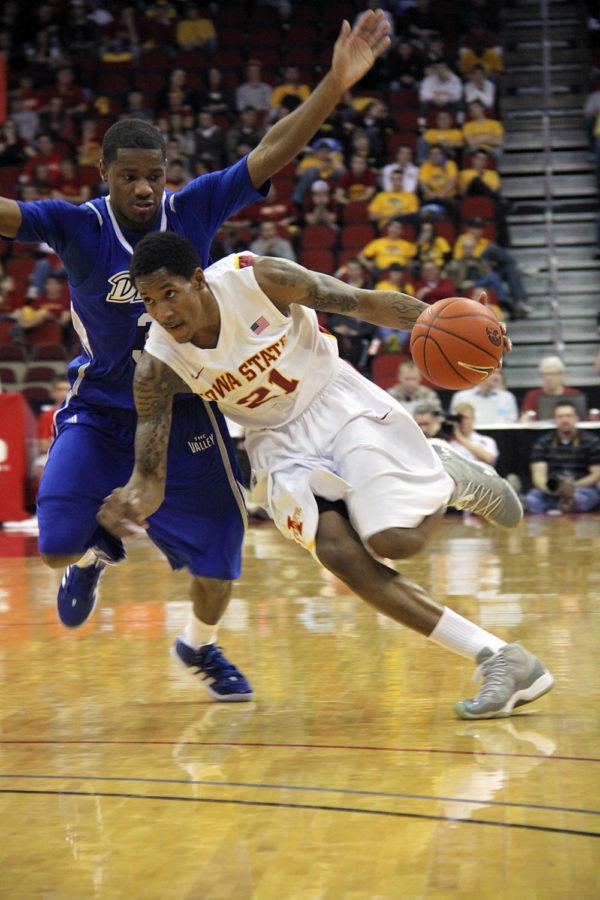 Iowa States Will Clyburn passes by a Drake Bulldog defender, pushing his way toward the basket. The Cyclones played at Wells Fargo Arena on Dec. 15 and beat their in-state rival, 86-77.
