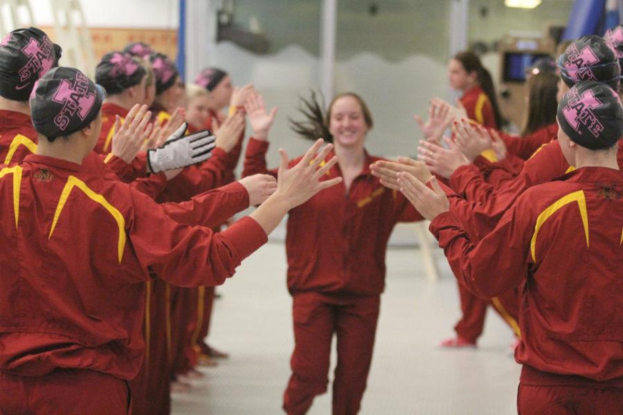 The swimming and diving team high fives the teammates as they are introduced before the dual swim meet against South Dakota and Nebraska on Friday at Beyer Hall. Cyclones defeated South Dakota 246-53 but fell to Nebraska 122.5-176.5.
